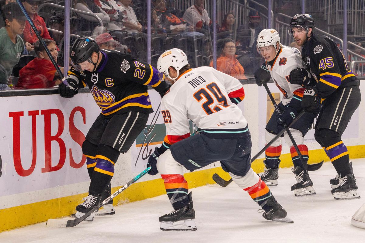 Coachella Valley Firebirds forward Lleyton Roed (29) battles Ontario Reign defenseman Joe Hicketts (27) for the puck along the boards during an AHL hockey game, Sunday, October 11, 2026, in Palm Desert, Calif.