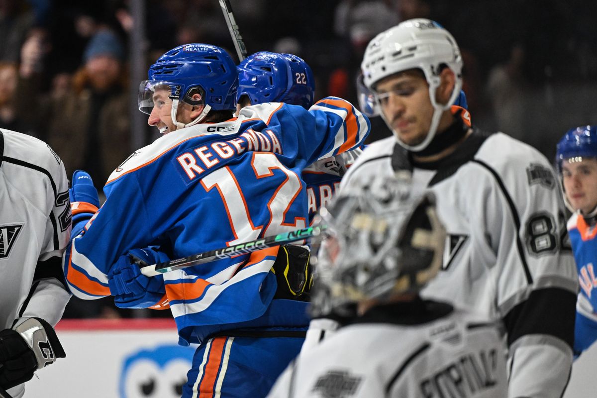 San Diego Gulls left winger Pavol Regenda (12) and center Ryan Carpenter (22) celebrate after scoring a goal while Ontario Reign defenseman Caleb Jones (82) looks disappointed during an AHL hockey game, Friday, December 27, 2024 in San Diego, Calif.