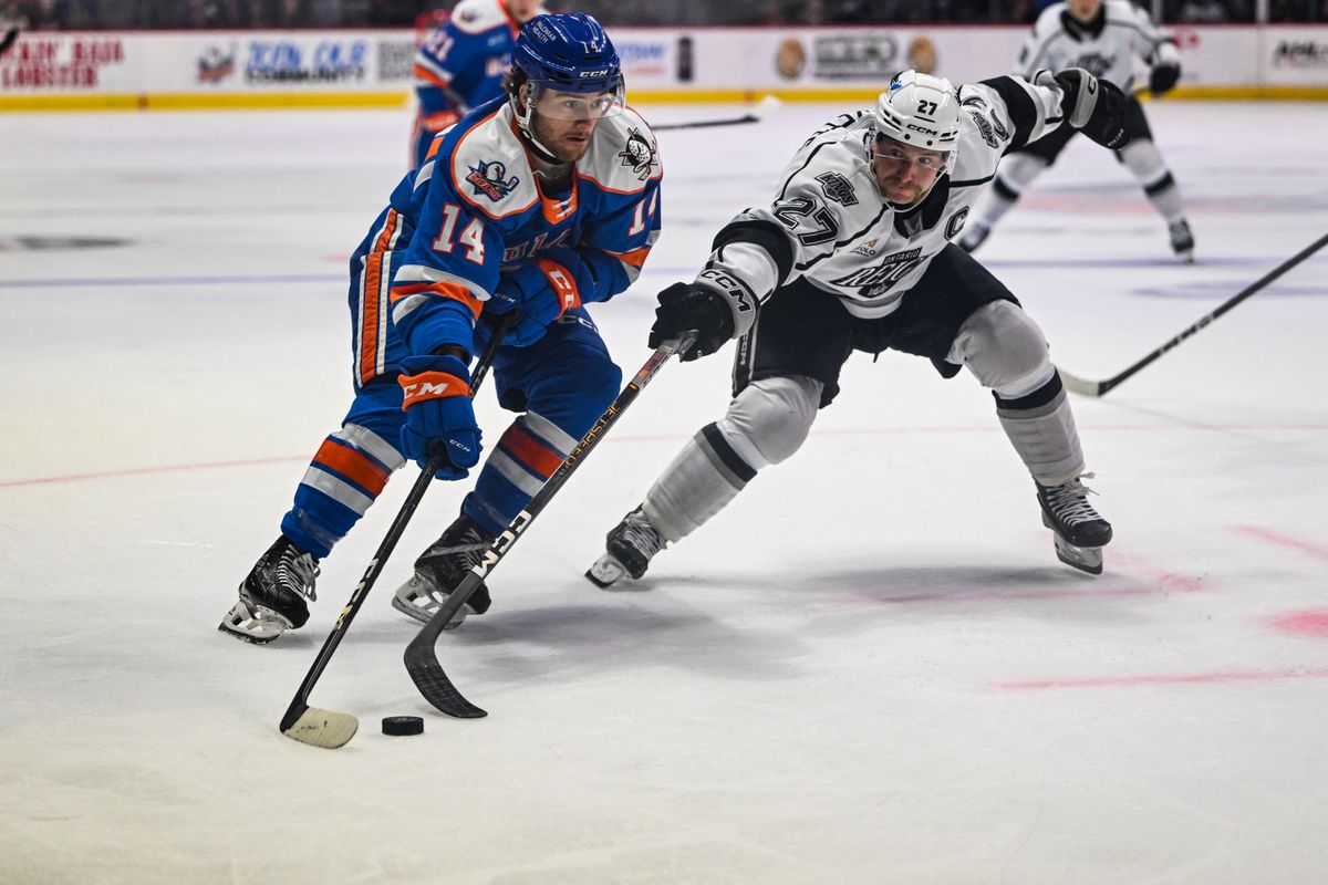 San Diego Gulls right winger Coulson Pitre (14) evades a stick check from Ontario Reign defenseman Joe Hicketts (27) during an AHL hockey game, Friday, December 27, 2024 in San Diego, Calif.
