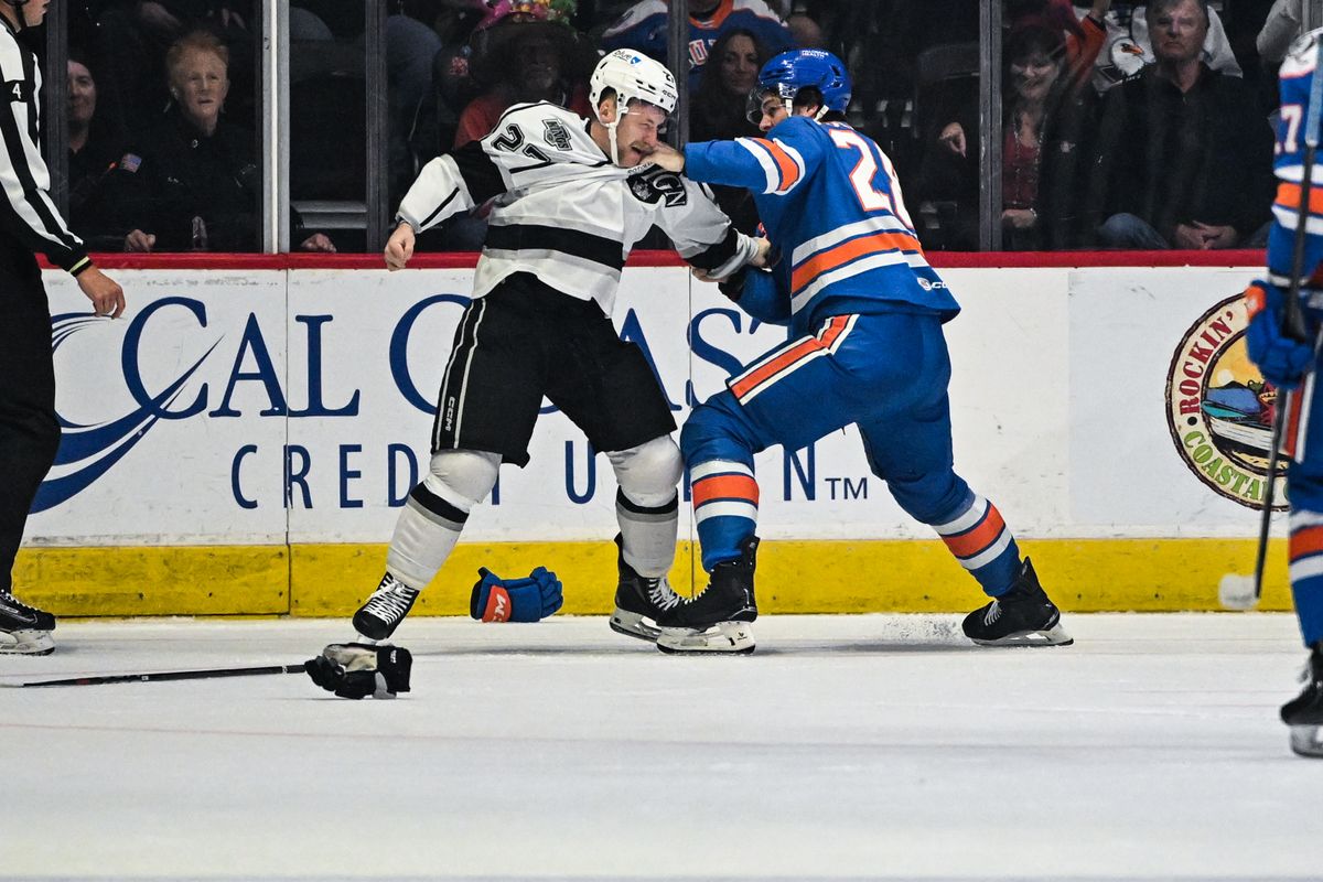 Ontario Reign defenseman Joe Hicketts (27) and San Diego Gulls right winger Judd Caulfield fight during an AHL hockey game, December 27, 2024 in San Diego, Calif.