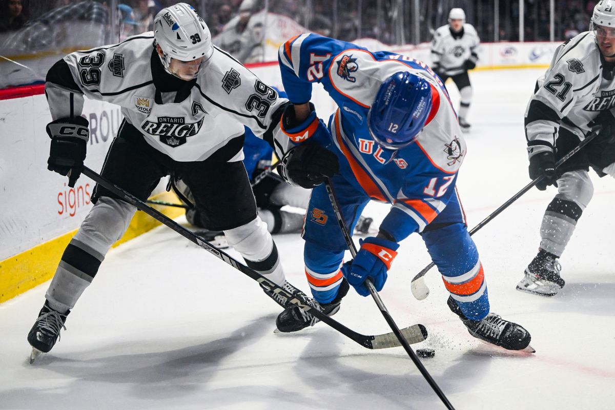Ontario Reign left winger Jeff Malott (39) steals the puck in a battle with San Diego Gulls left winger Pavol Regenda (12) during an AHL hockey game, Friday, December 27, 2024 in San Diego, Calif.