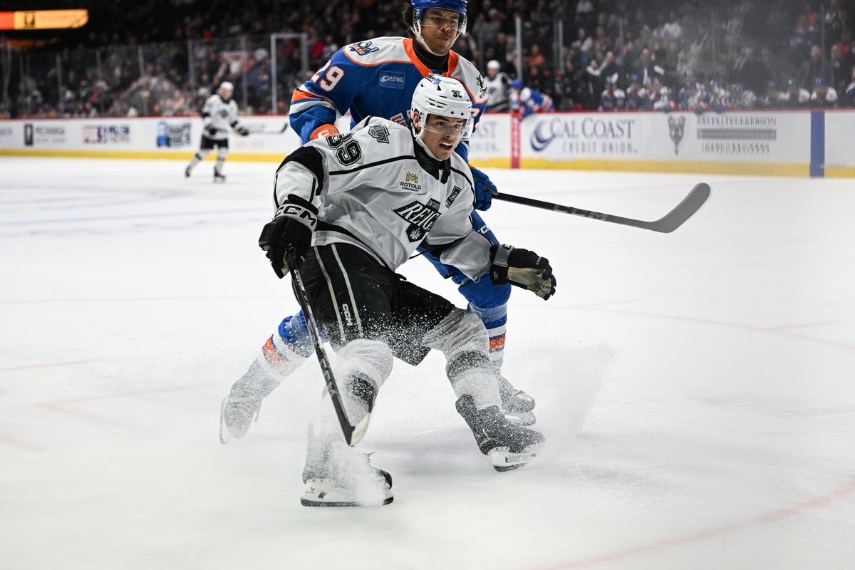 Ontario Reign left winger Jeff Malott (39) and San Diego Gulls defenseman Rodwin Dionicio (29) battle for a puck in the corner during an AHL hockey game, Friday, December 27, 2024 in San Diego, Calif.