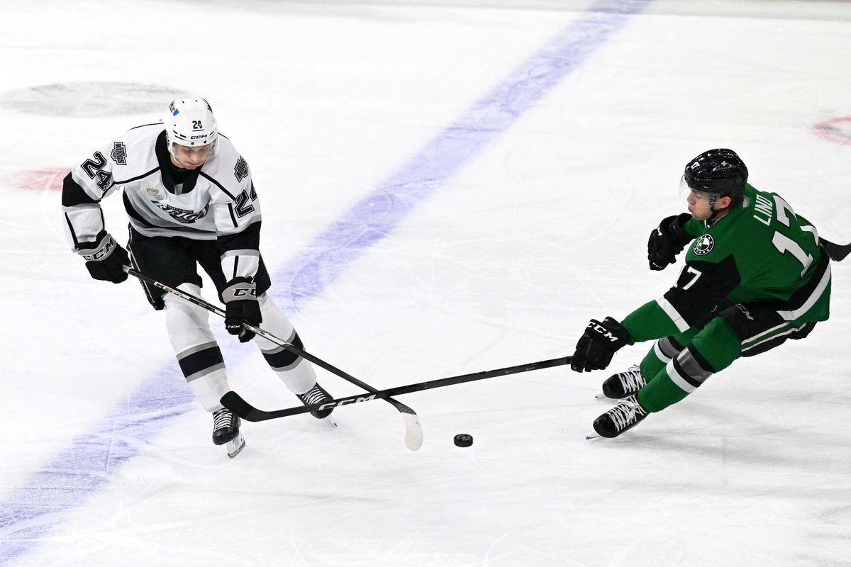 Ontario Reign defender Angus Booth (24) fights for the puck during an AHL hockey game agains’t the Texas Stars, Tuesday December 9th, 2025 in Ontario, Calif.