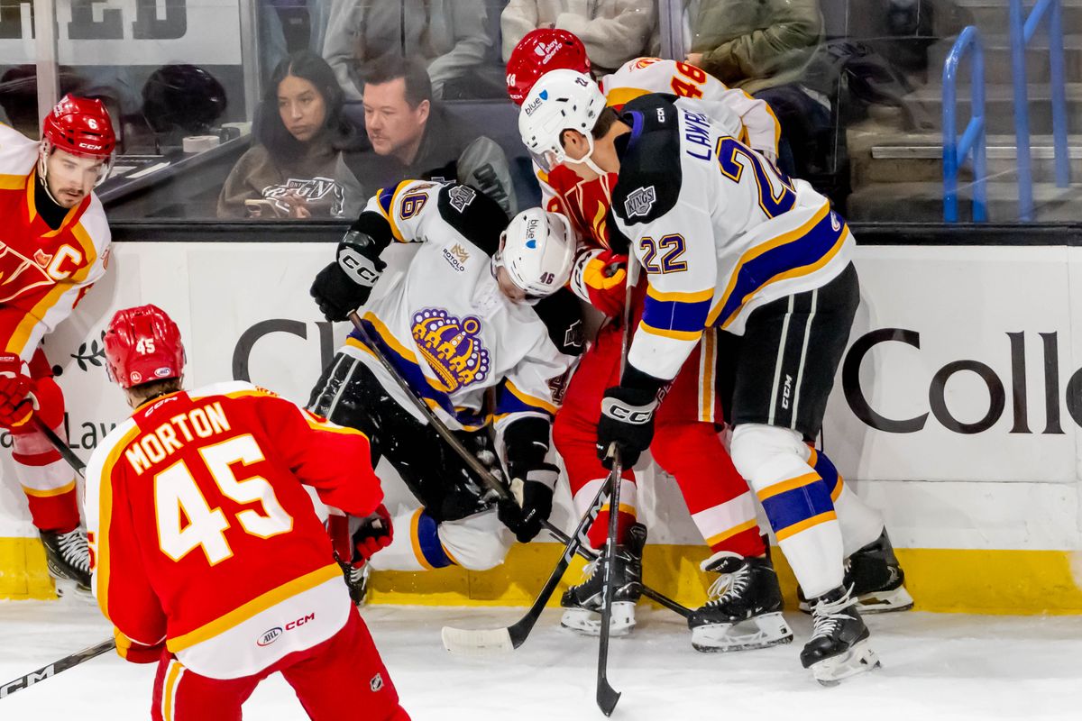 Ontario Reign left wing Kenta Isogai (46) and center Kaleb Lawrence (22) fight to gain possession of the puck during an AHL game against the Calgary Wranglers, Tuesday, Oct. 20, 2026, in Ontario, California. Ontario Reign left wing Kenta Isogai (46) and center Kaleb Lawrence (22) fight to gain possession of the puck during an AHL game against the Calgary Wranglers, Tuesday, Oct. 20, 2026, in Ontario, California.