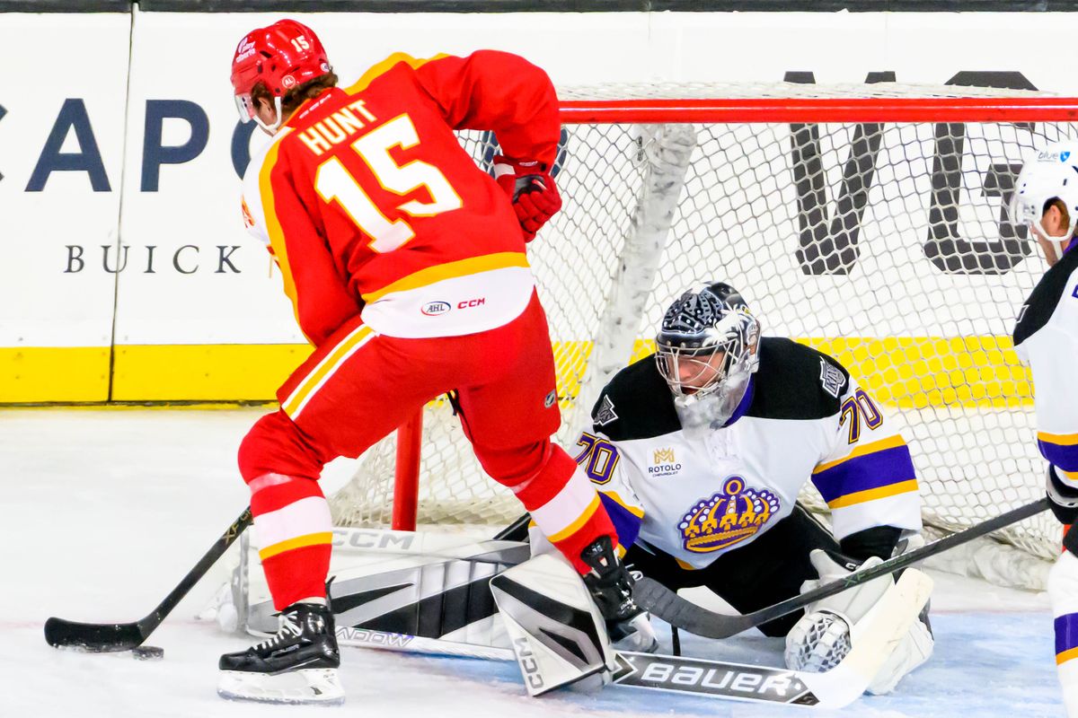 Ontario Reign goalie Carter George (70) blocks a shot from Calgary Wranglers left wing Dryden Hunt (15) during an AHL game against the Calgary Wranglers, Tuesday, Oct. 20, 2026, in Ontario, California. Ontario Reign goalie Carter George (70) blocks a shot from Calgary Wranglers left wing Dryden Hunt (15) during an AHL game against the Calgary Wranglers, Tuesday, Oct. 20, 2026, in Ontario, California.
