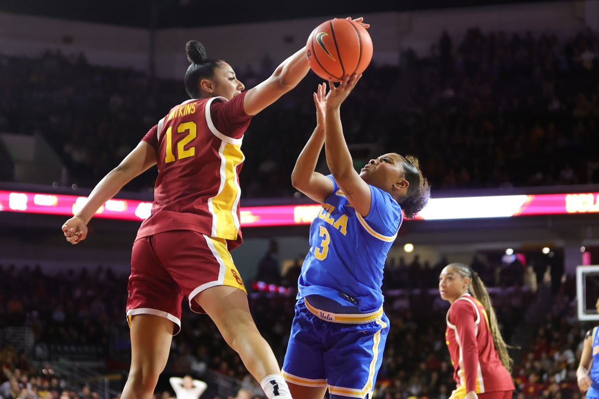 #12 PG Juju Watkins of USC blocks the shot of #3 G Londynn Jones of UCLA during a NCAA basketball game on February 13, 2025 in Los Angeles, CA.
