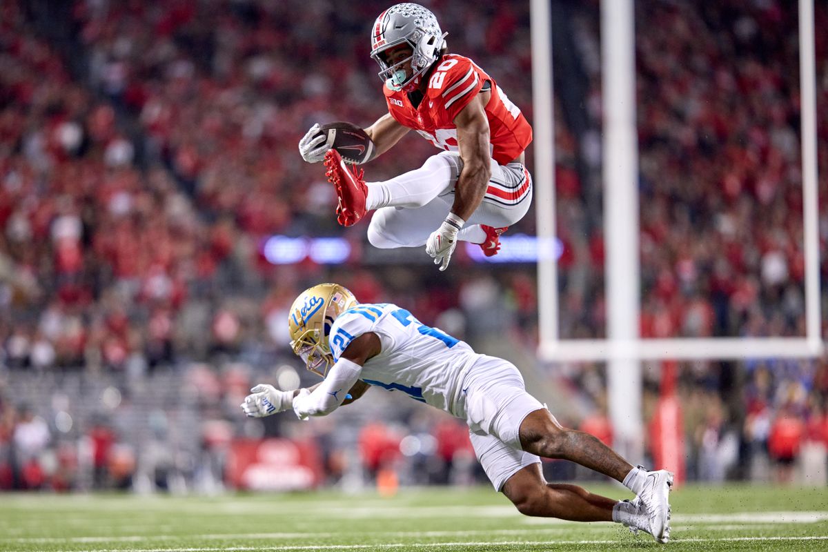 Ohio State Buckeye leaps over UCLA Bruins in Columbus, Ohio. 