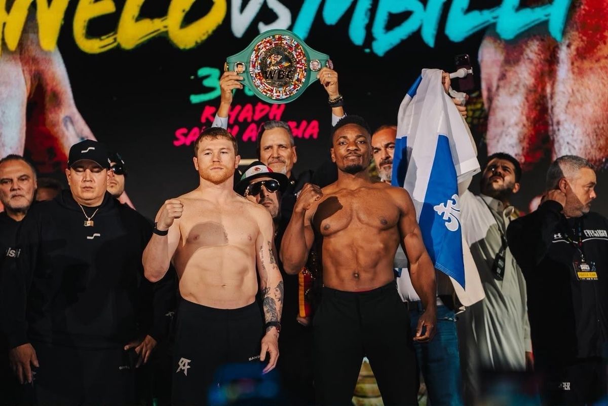 Alvarez and Mbilli pose with the WBC belt after making weight. They fight Saturday at Kingdom Arena. Alvarez and Mbilli pose with the WBC belt after making weight. They fight Saturday at Kingdom Arena.