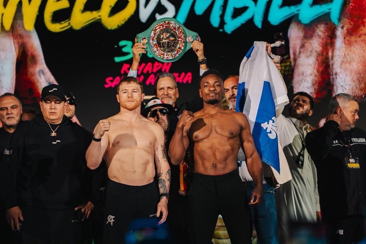 Alvarez and Mbilli pose with the WBC belt after making weight. They fight Saturday at Kingdom Arena. Alvarez and Mbilli pose with the WBC belt after making weight. They fight Saturday at Kingdom Arena.