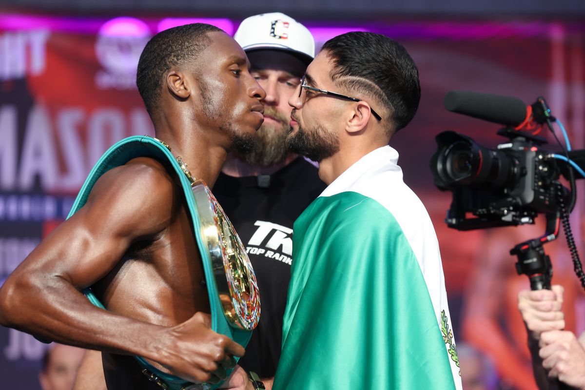 Bruce Carrington and Rene Palacios face off Friday after making weight for Saturday's WBC featherweight title fight in Cleveland.