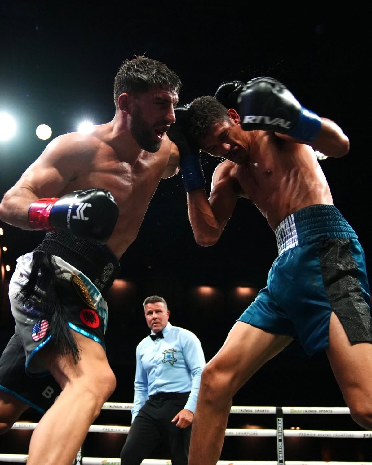 Ermal Hadribeaj presses Sebastian Fundora on the inside as the referee looks on. Ermal Hadribeaj presses Sebastian Fundora on the inside as the referee looks on.