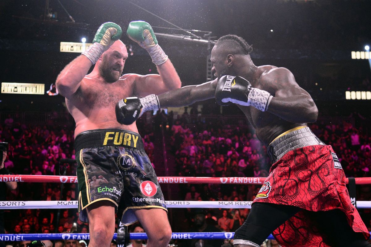Oct 9, 2021; Las Vegas, Nevada, USA; Deontay Wilder (red/black trunks) and Tyson Fury (black/gold trunks) box during their WBC/Lineal heavyweight championship boxing match at T-Mobile Arena. Mandatory Credit: Joe Camporeale-USA TODAY Sports Oct 9, 2021; Las Vegas, Nevada, USA; Deontay Wilder (red/black trunks) and Tyson Fury (black/gold trunks) box during their WBC/Lineal heavyweight championship boxing match at T-Mobile Arena. Mandatory Credit: Joe Camporeale-USA TODAY Sports