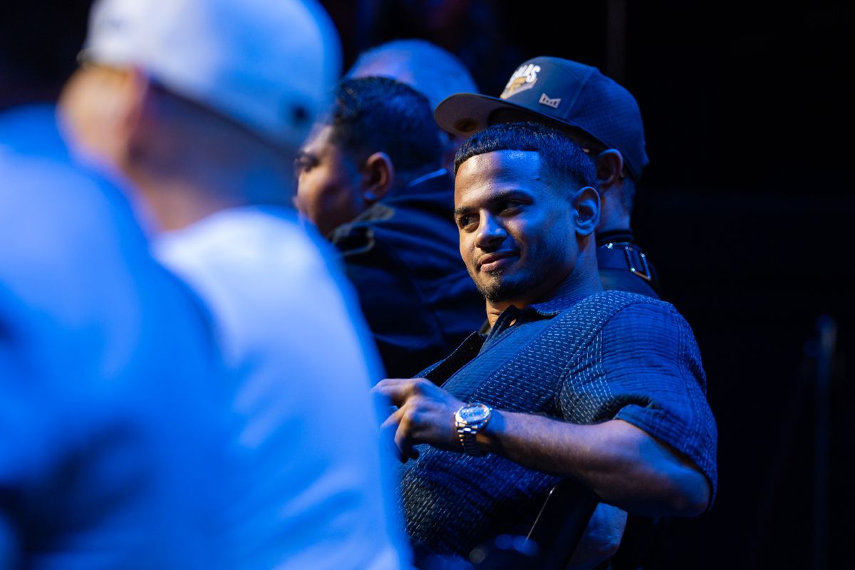 Rolly Romero smirks in the direction of Teofimo Lopez and his father, Teofimo Lopez Sr. during Thursday's press conference.