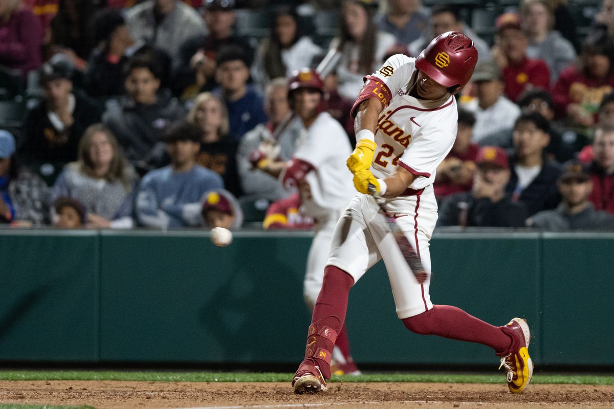USC Trojan catcher Augie Lopez (24) makes a base hit during an NCAA Men's baseball game between the USC Trojans and Pepperdine Wave Friday February 13,2026 at Dedeaux Field in Los Angeles Calif