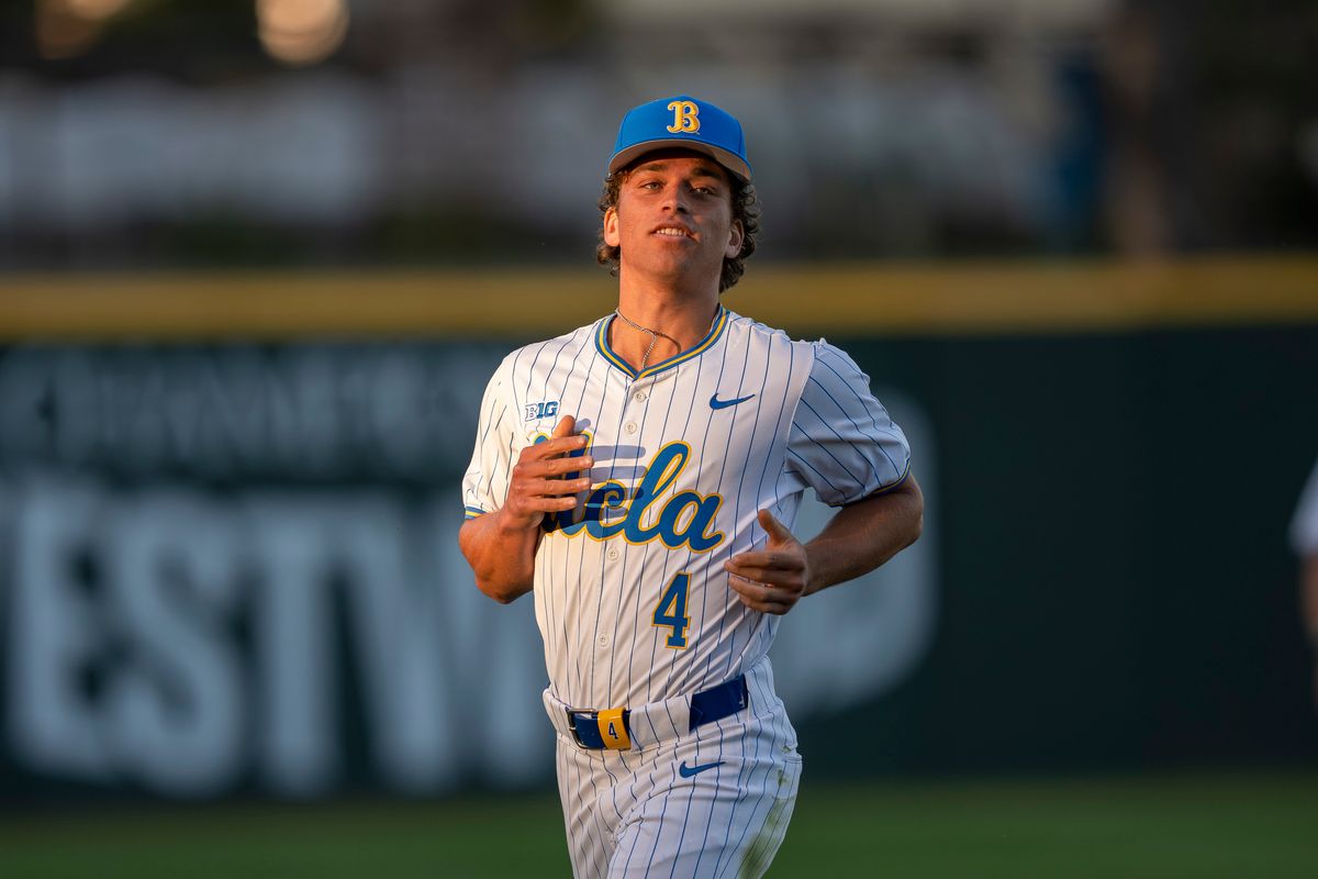 UCLA infielder, Phoenix Call (4) retrieving his glove during a NCAA baseball game against UC San Diego on February 13, 2026 at Jackie Robinson Stadium in Los Angeles, CA.