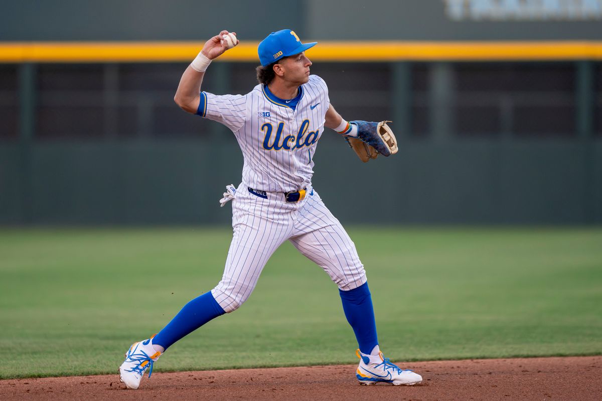 UCLA infielder, Roch Cholowsky fielding a ball to first base during a NCAA baseball game against UC San Diego on February 13, 2026 at Jackie Robinson Stadium in Los Angeles, CA.