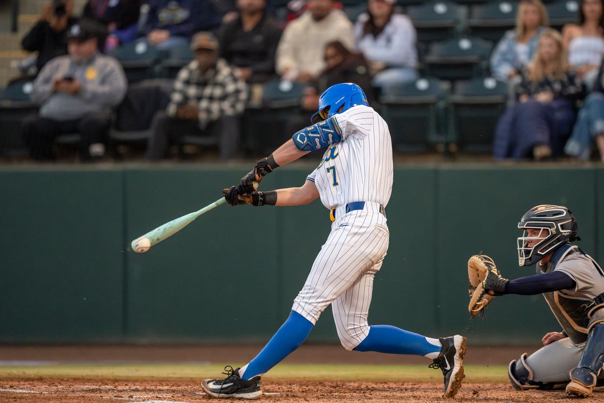UCLA infielder, Roman Martin (7) at bat, mid-hit during a NCAA baseball game against UC San Diego on February 13, 2026 at Jackie Robinson Stadium in Los Angeles, CA.