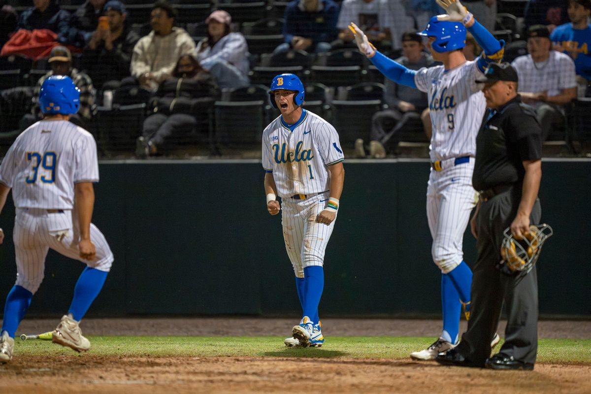 UCLA infielder and outfielder, Roch Cholowsky (1) and Will Gasparino (9), respectively, celebrating a double during a NCAA baseball game against UC San Diego on February 13, 2026 at Jackie Robinson Stadium in Los Angeles, CA.