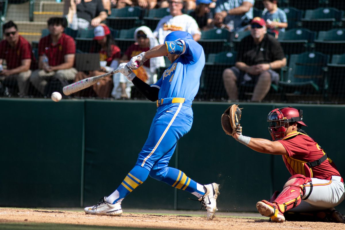   UCLA infielder, Pheonix Call (4) at bat, mid hit during an NCAA baseball game against USC on April 4th, 2026 at Jackie Robinson Stadium in Los Angeles, CA.