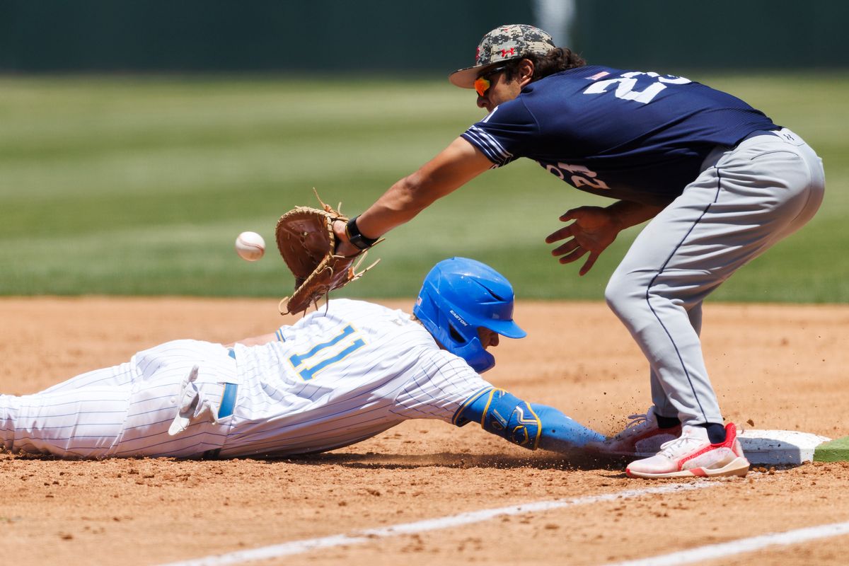 Payton Brennan #11 of the UCLA Bruins slides back to first base during the game against St. Mary’s Gaels at Jackie Robinson Stadium on May 29, 2026 in Los Angeles, California. Payton Brennan #11 of the UCLA Bruins slides back to first base during the game against St. Mary’s Gaels at Jackie Robinson Stadium on May 29, 2026 in Los Angeles, California.