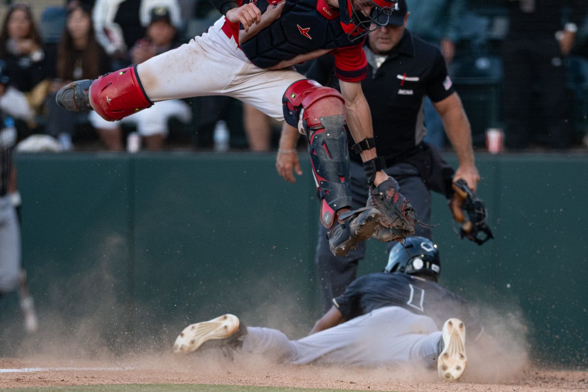 Cal Poly Mustangs outfielder Casey Murray Jr (1) slides to home plate and scores during an NCAA regional championship elimination game between the Saint Mary's College Gaels and Cal Poly Mustangs on May 31, 2026 at Jackie Robinson Stadium in Los Angeles Calif.