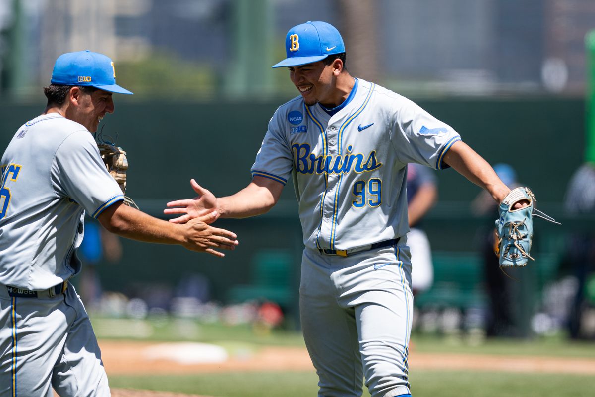 UCLA Bruins right-hand-pitcher Angel Cervantes (99) daps up with team mates during an NCAA regional championship elimination game between the Saint Mary's College Gaels and UCLA Bruins on May 31, 2026 at Jackie Robinson Stadium in Los Angeles Calif.