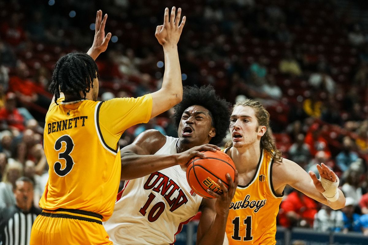 UNLV Runnin’ Rebels forward Jacob Bannarbie (10) drives towards the basket while guarded by Wyoming Gavin Gores (11) and guard Khaden Bennett (3) during the first round of a Mountain West Championship tournament game between the UNLV Runnin’ Rebels and the Wyoming Cowboys, Wednesday March 11, 2026 in Las Vegas, Nev.
