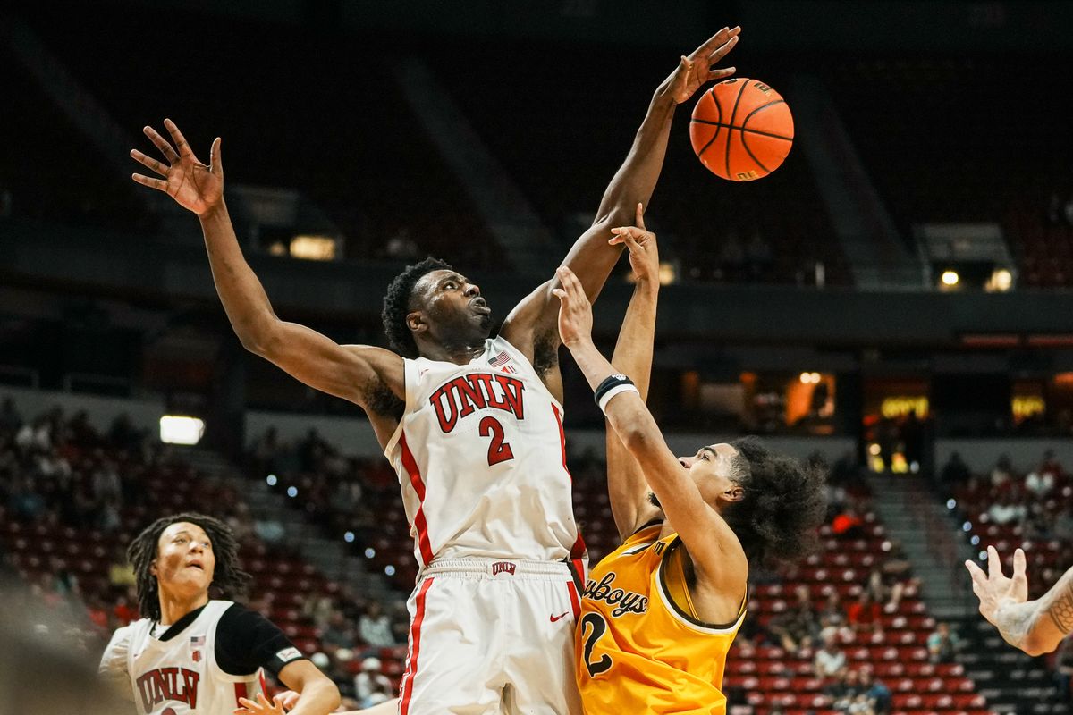 UNLV Runnin’ Rebels forward Kimani Hamilton (2) blocks a shot from Wyoming guard Nasir Meyer (2) during the first round of a Mountain West Championship tournament game between the UNLV Runnin’ Rebels and the Wyoming Cowboys, Wednesday March 11, 2026 in Las Vegas, Nev