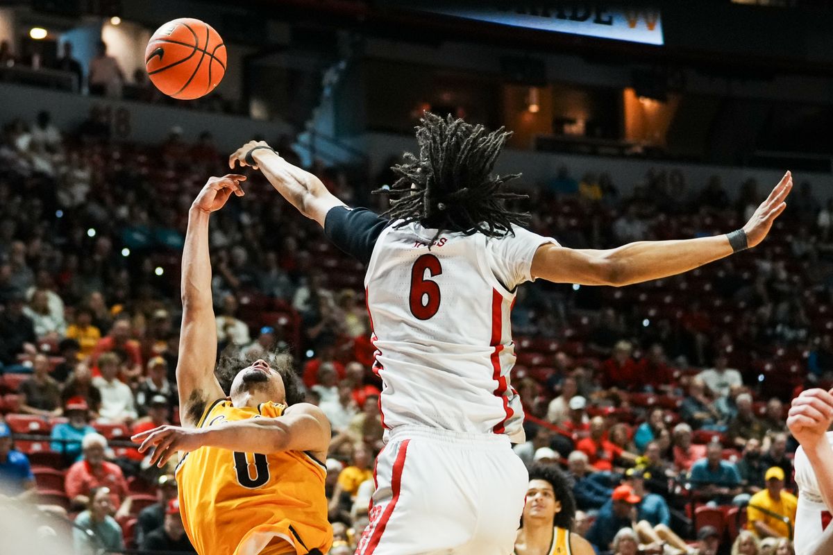 UNLV Runnin’ Rebels forward Tyrin Jones (6) blocks a shot from Wyoming guard Uriah Rojas (0) during the first round of a Mountain West Championship tournament game between the UNLV Runnin’ Rebels and the Wyoming Cowboys, Wednesday March 11, 2026 in Las Vegas, Nev.