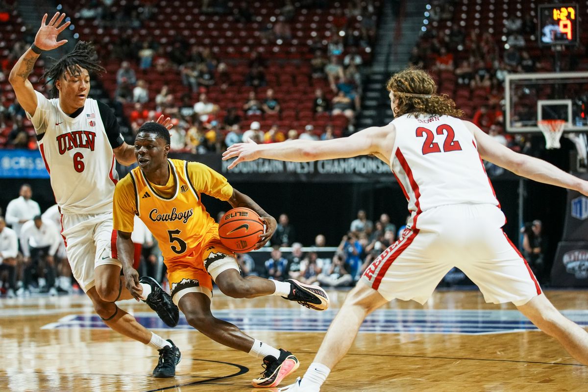 UNLV Runnin’ Rebels forward Tyrin Jones (6) and forward Walter Brown (22) guard Wyoming Leland Walker down the court during the first round of a Mountain West Championship tournament game between the UNLV Runnin’ Rebels and the Wyoming Cowboys, Wednesday March 11, 2026 in Las Vegas, Nev.