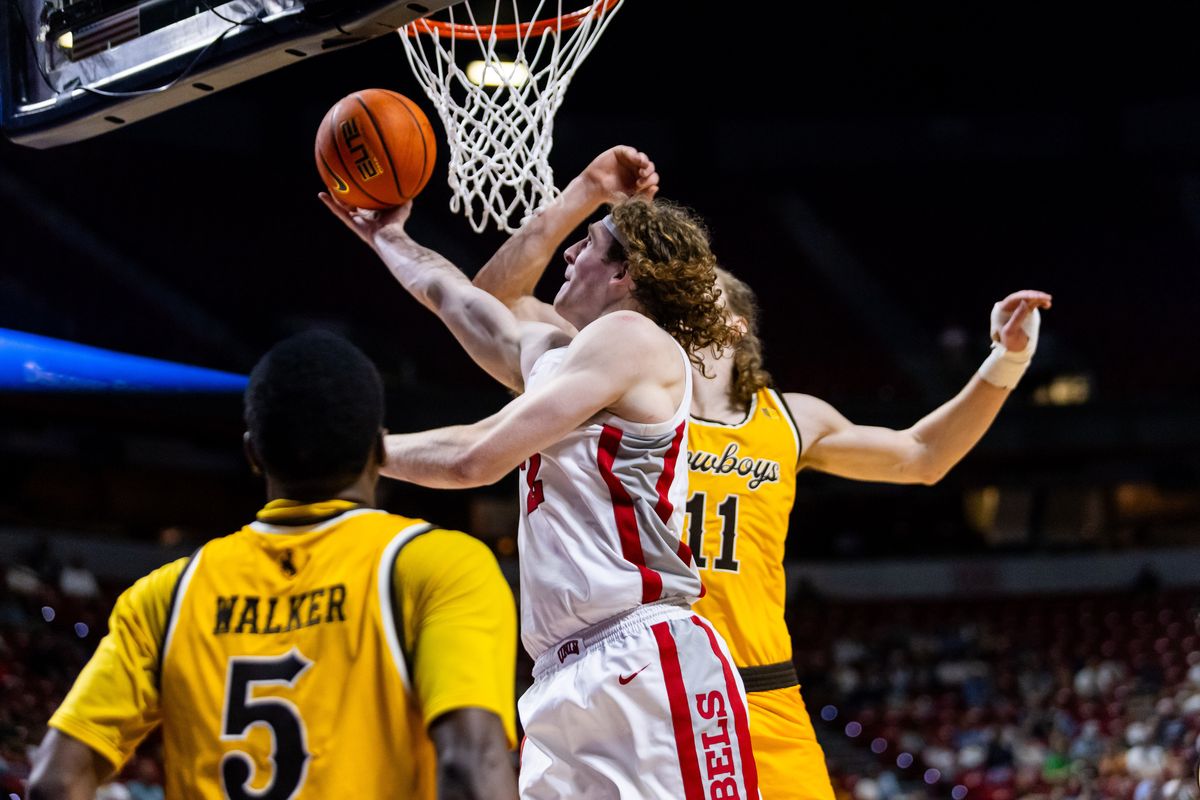 UNLV Runnin’ Rebels forward Walter Brown (22) goes for a contested lay-up during the first round of a Mountain West Championship tournament game between the UNLV Runnin’ Rebels and the Wyoming Cowboys, Wednesday March 11, 2026 in Las Vegas, Nev.