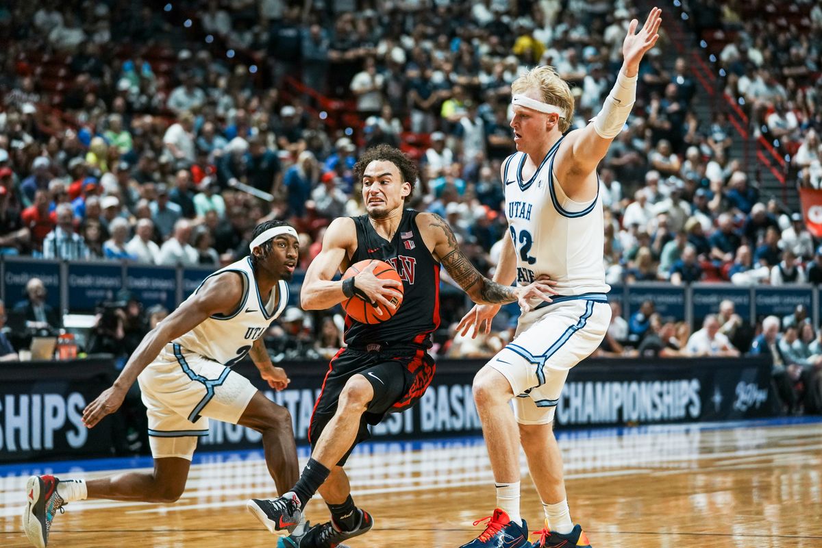 UNLV guard Dra Gibbs-Lawhorn (0) drives throughUtah State MJ Collins (2) and forward Karson Templin (22) during the second round of a Mountain West Championship tournament game between the UNLV and Utah State on Thursday March 12, 2026 in Las Vegas, Nev.