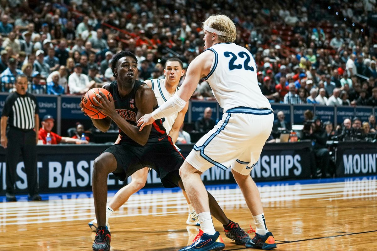UNLV forward Kimani Hamilton (2) looks past Utah State forward Karson Templin (22) during the second round of a Mountain West Championship tournament game between the UNLV and Utah State on Thursday March 12, 2026 in Las Vegas, Nev.