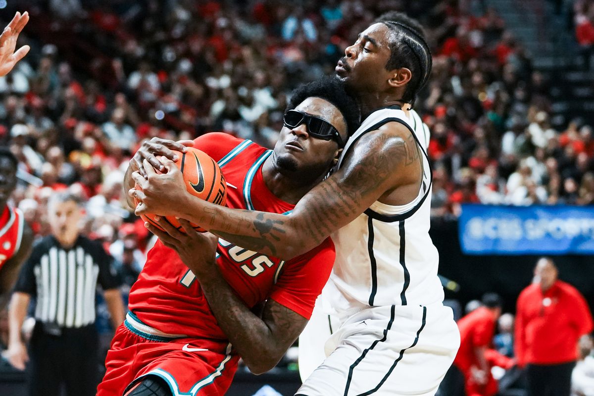 New Mexico guard Deyton Albury (1) attempts to drive through San Diego State Reese Dizon-Waters (39) during semifinal Mountain West Championship tournament game between San Diego State and New Mexico on Friday March 13, 2026 in Las Vegas, Nev.