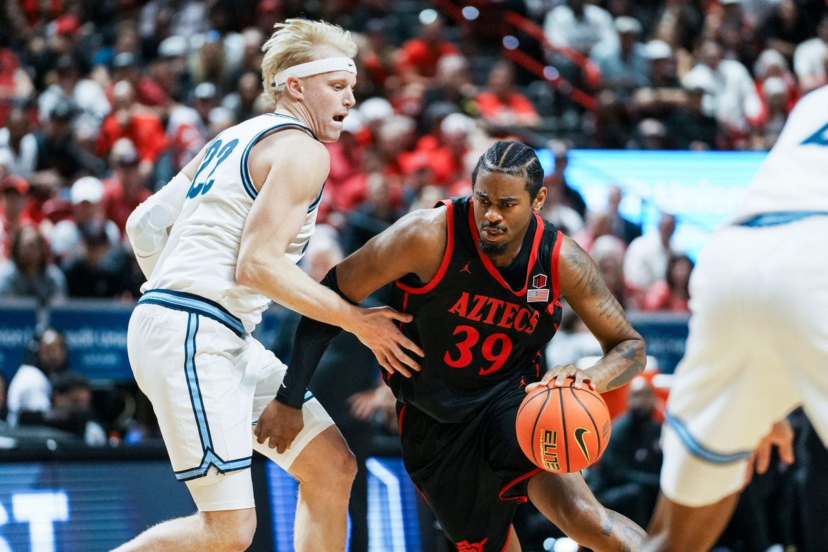 San Diego State guard Reese Dixon-Waters (39) attempts to take the ball around Utah State forward Karson Templin (22) reach for control of the ball during final Mountain West Championship tournament game between San Diego State and Utah State on Saturday March 14, 2026 in Las Vegas, Nev.