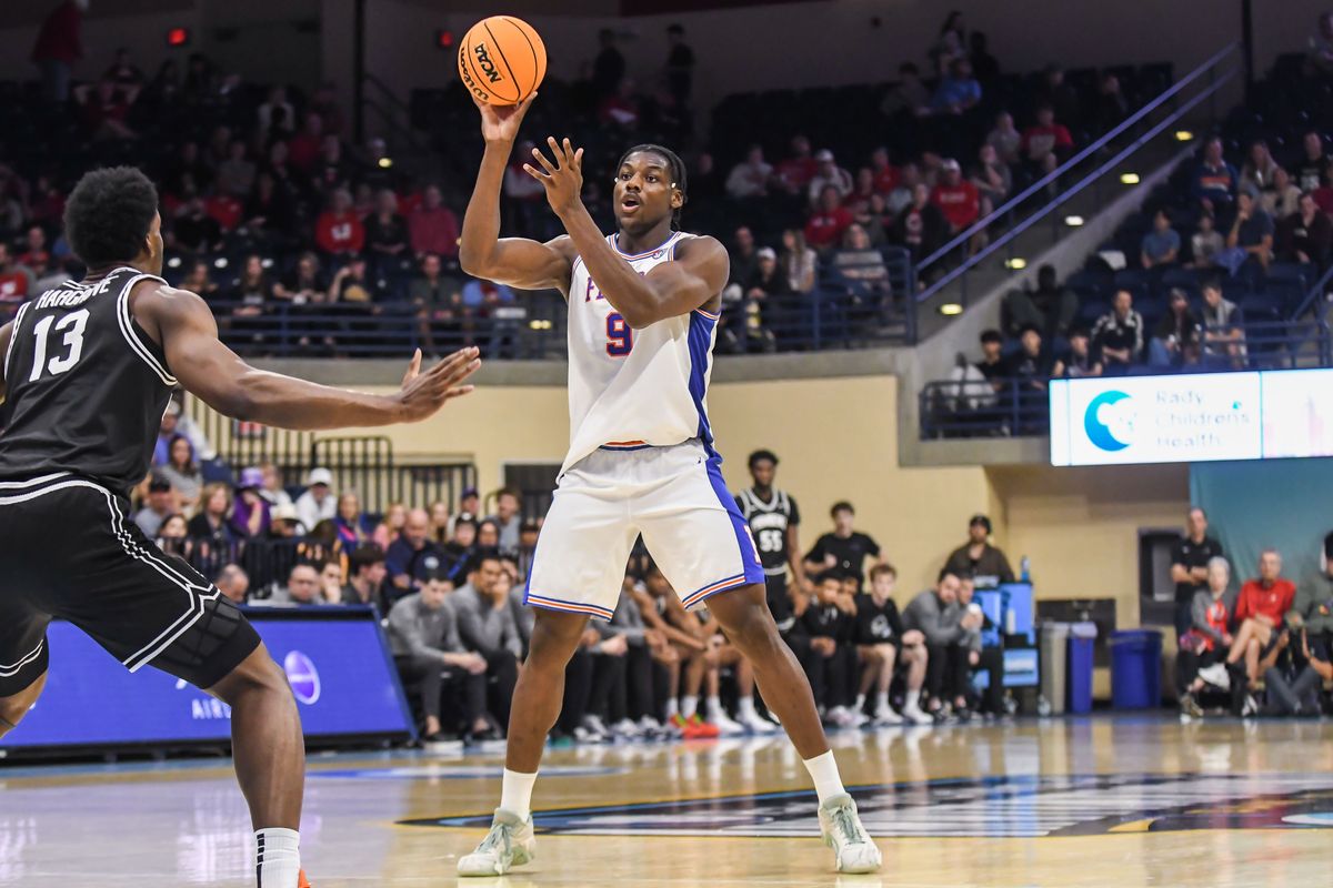 Florida center Rueben Chinyelu (9) handles the basketball, during an NCAA basketball  game against Providence, Friday November 28, 2025 in  San Diego, California.