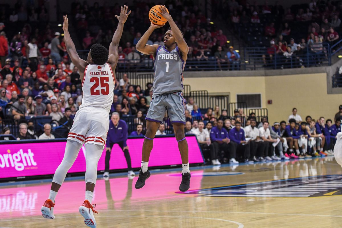 TCU guard Jayden Pierre (1) shoots a three point shot over Wisconsin guard John Blackwell (25) during an NCAA basketball  game against Wisconsin, Friday November 28, 2025 in  San Diego, California.