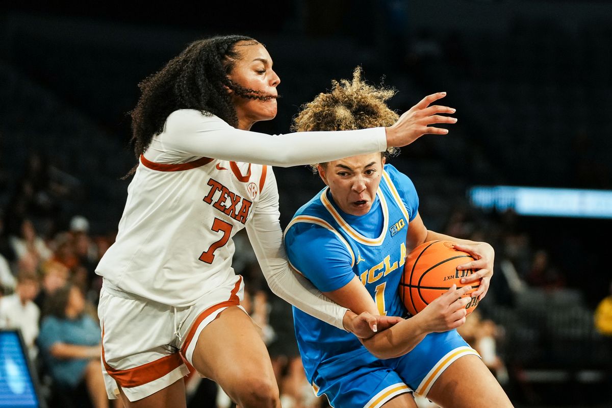 UCLA guard Kiki Rice (1) drives towards the basket while guarded by Texas Jordan Lee (7) during second half of college basketball game against Texas on Wednesday, Nov. 26, 2025 during the Players Era tournament at Michelob Ultra Arena in Las Vegas.