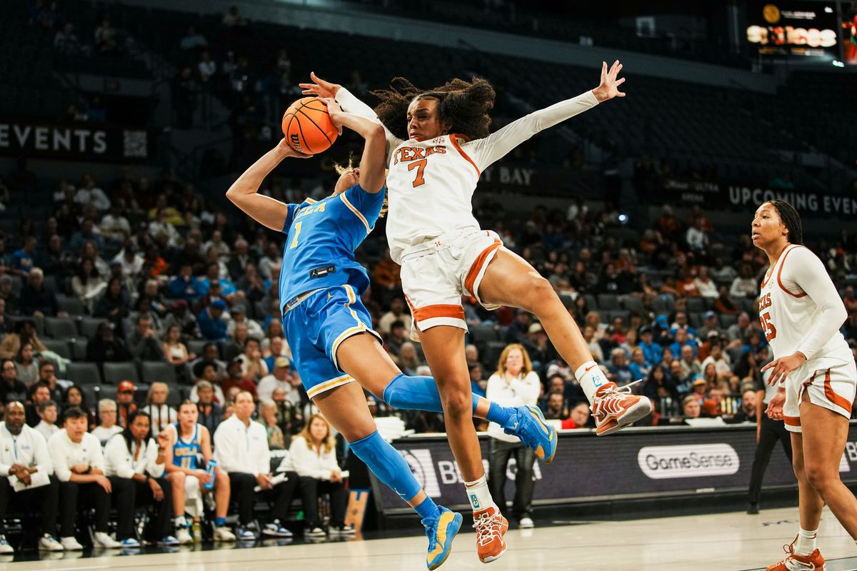 Texas guard Bryanna Preston (1) attempts to block a shot from UCLA Kiki Rice  during second half of college basketball game against UCLA on Wednesday, Nov. 26, 2025 during the Players Era tournament at Michelob Ultra Arena in Las Vegas.