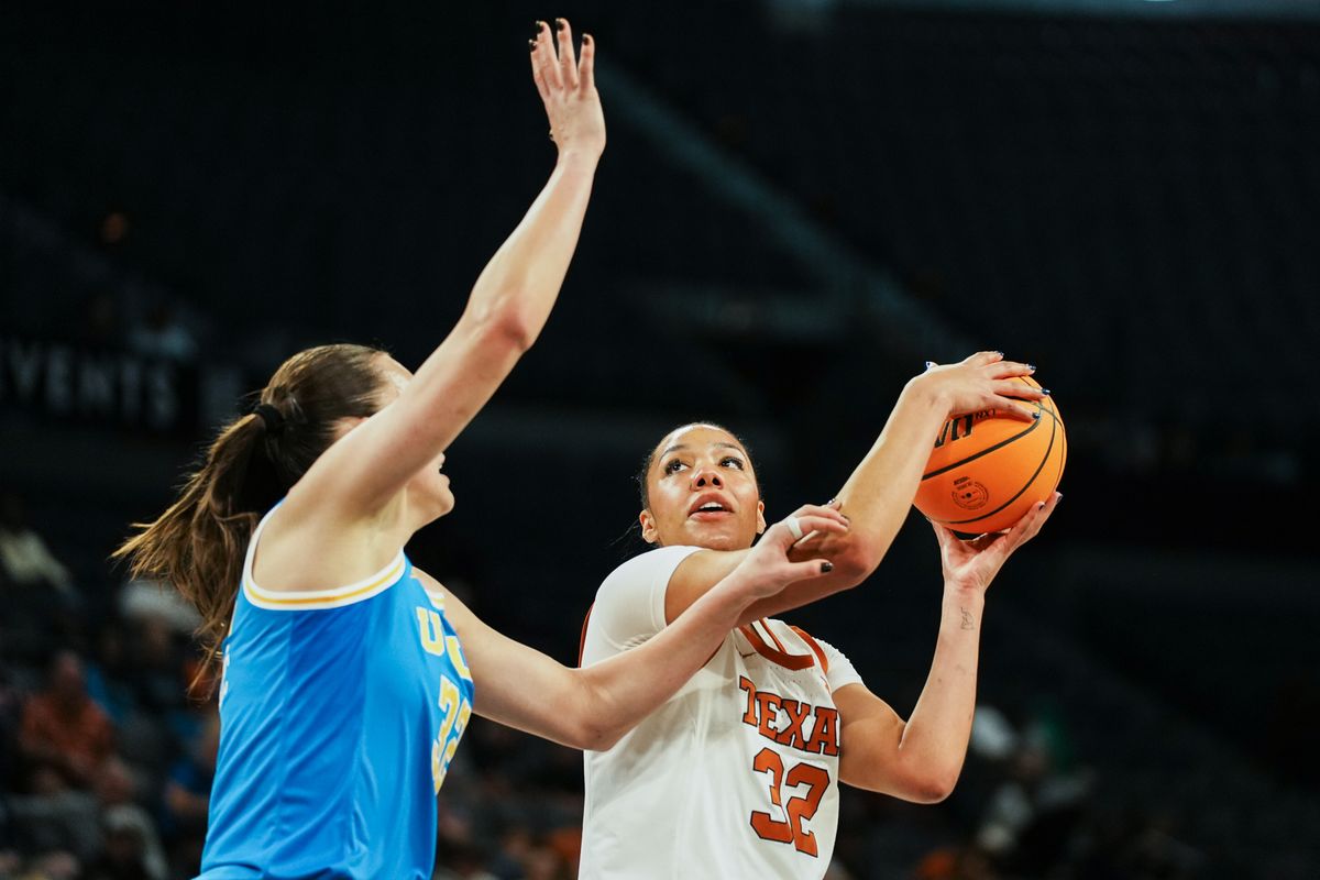 Texas forward Teya Sidberry (32) eyes the basket while guarded by UCLA Angela Dugalic (32) during first half of college basketball game against UCLA on Wednesday, Nov. 26, 2025 during the Players Era tournament at Michelob Ultra Arena in Las Vegas.