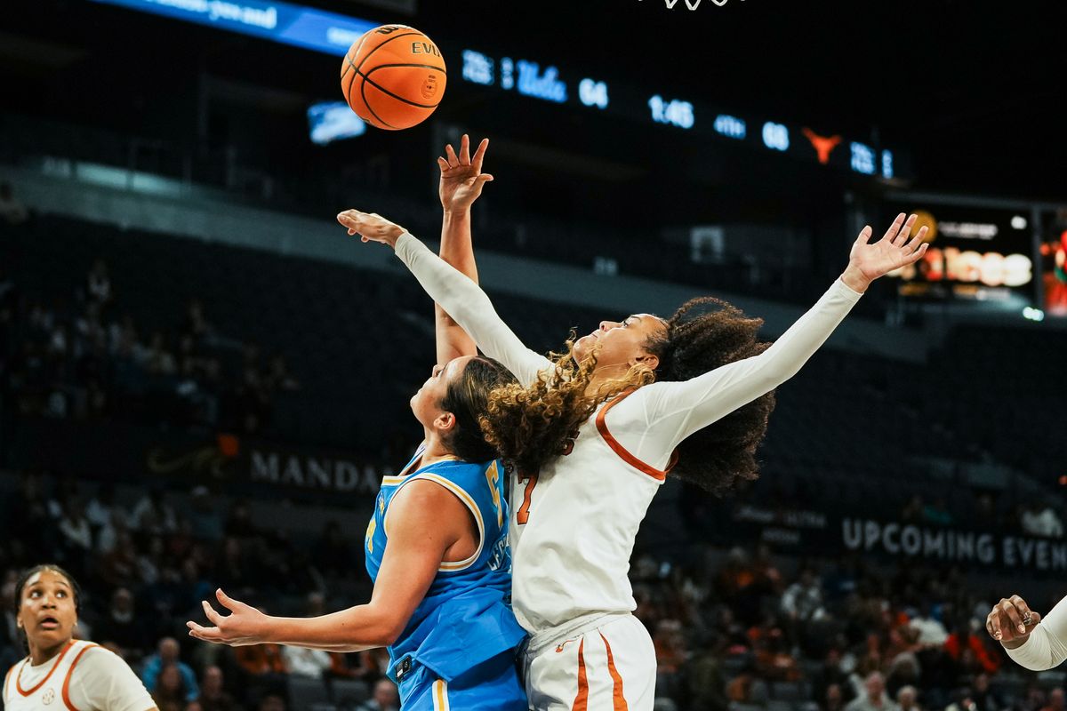 Texas guard Jordan Lee (7) attempts to block a shot from UCLA Charlisse Leger-Walker (5) during second half of college basketball game against UCLA on Wednesday, Nov. 26, 2025 during the Players Era tournament at Michelob Ultra Arena in Las Vegas.