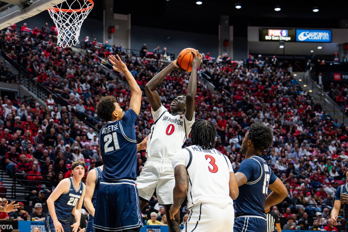Freshman Forward Magoon Gwath #0 fighting for a basket against Utah State on December 28, 2024 in San Diego, CA Freshman Forward Magoon Gwath #0 fighting for a basket against Utah State on December 28, 2024 in San Diego, CA