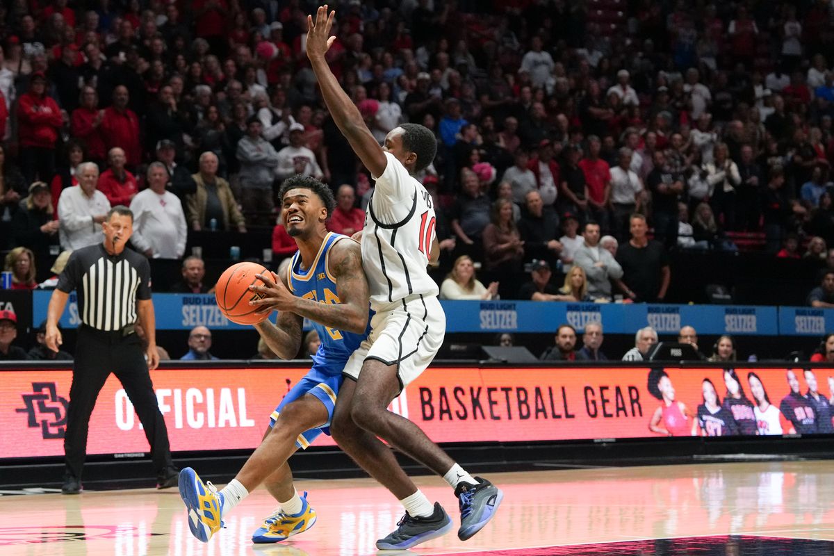 UCLA guard Donovan Dent (2) fights to shoot the ball during an NCAA basketball game against SDSU, Friday October 17, 2025 in San Diego, California.