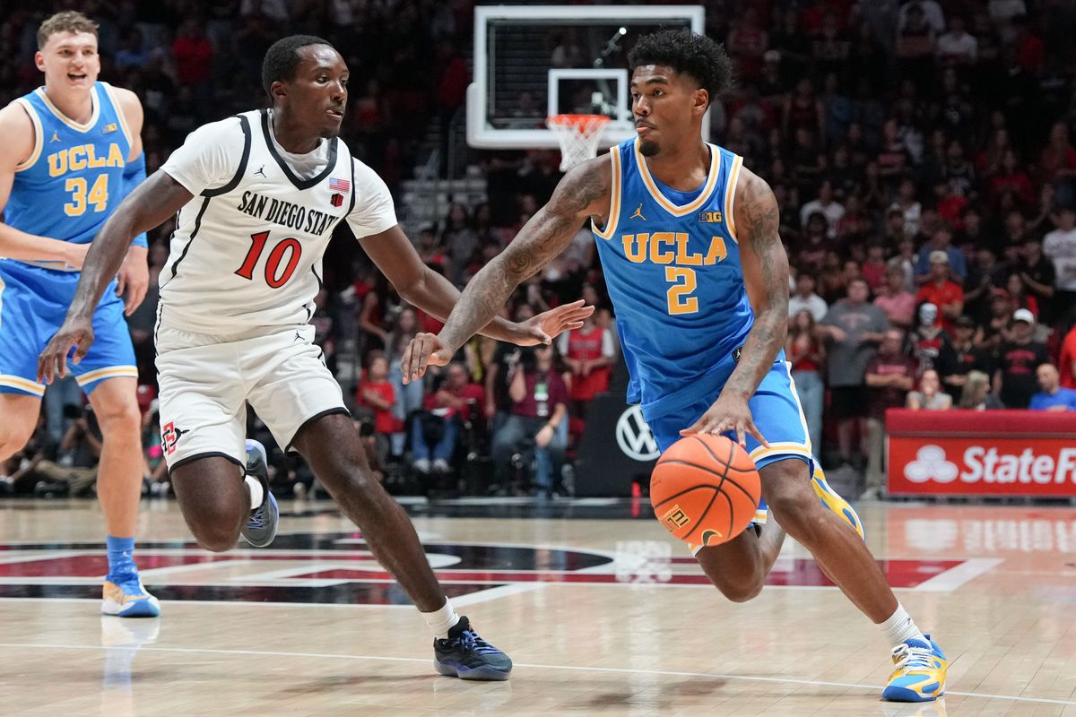 UCLA guard Donovan Dent (2) dribbles past defenders during an NCAA basketball game against SDSU, Friday October 17, 2025 in San Diego, California. UCLA guard Donovan Dent (2) dribbles past defenders during an NCAA basketball game against SDSU, Friday October 17, 2025 in San Diego, California.