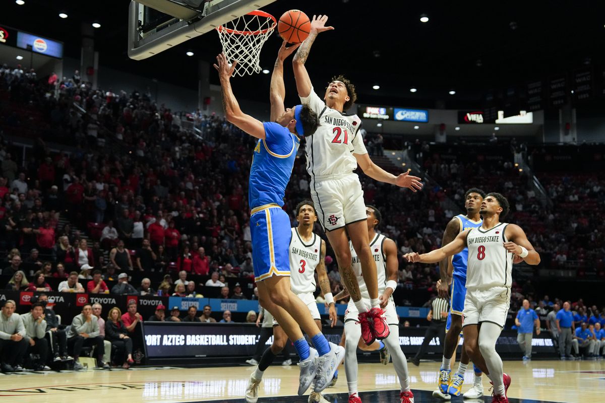UCLA guard Jamar Brown (4) goes up for a layup against SDSU guard Miles Byrd (21) during an NCAA basketball game, Friday October 17, 2025 in San Diego, California.