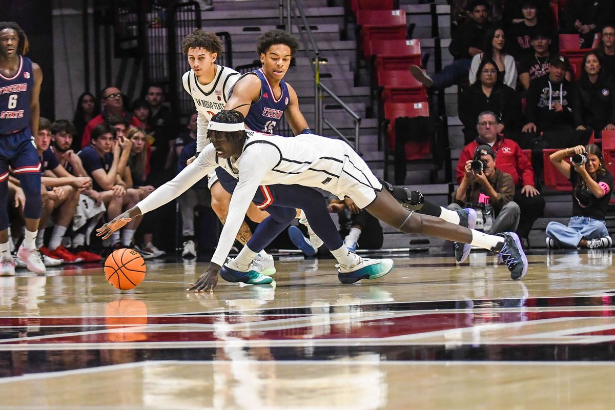 SDSU  Magoon Gwath (0&nbsp;) dives to recover the loose ball during an NCAA men’s basketball game against  Fresno State.  Saturday January 10, 2026 in  San Diego, California.
