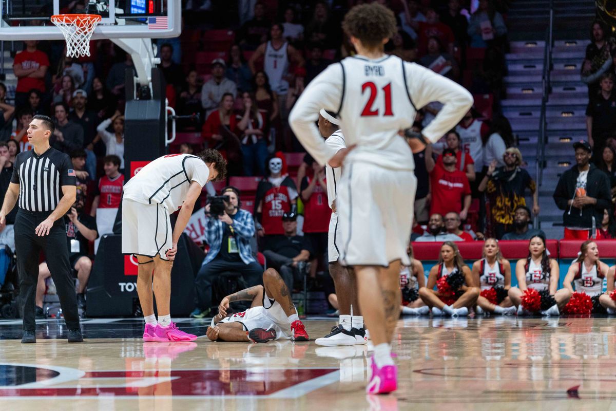 San Diego State guard Miles Byrd (21) looks on as guard Reese Dixon-Waters (39) lies injured during an NCAA Basketball game between New Mexico and San Diego State, Saturday January 17, 2026 at Viejas Arena in San Diego, Calif.