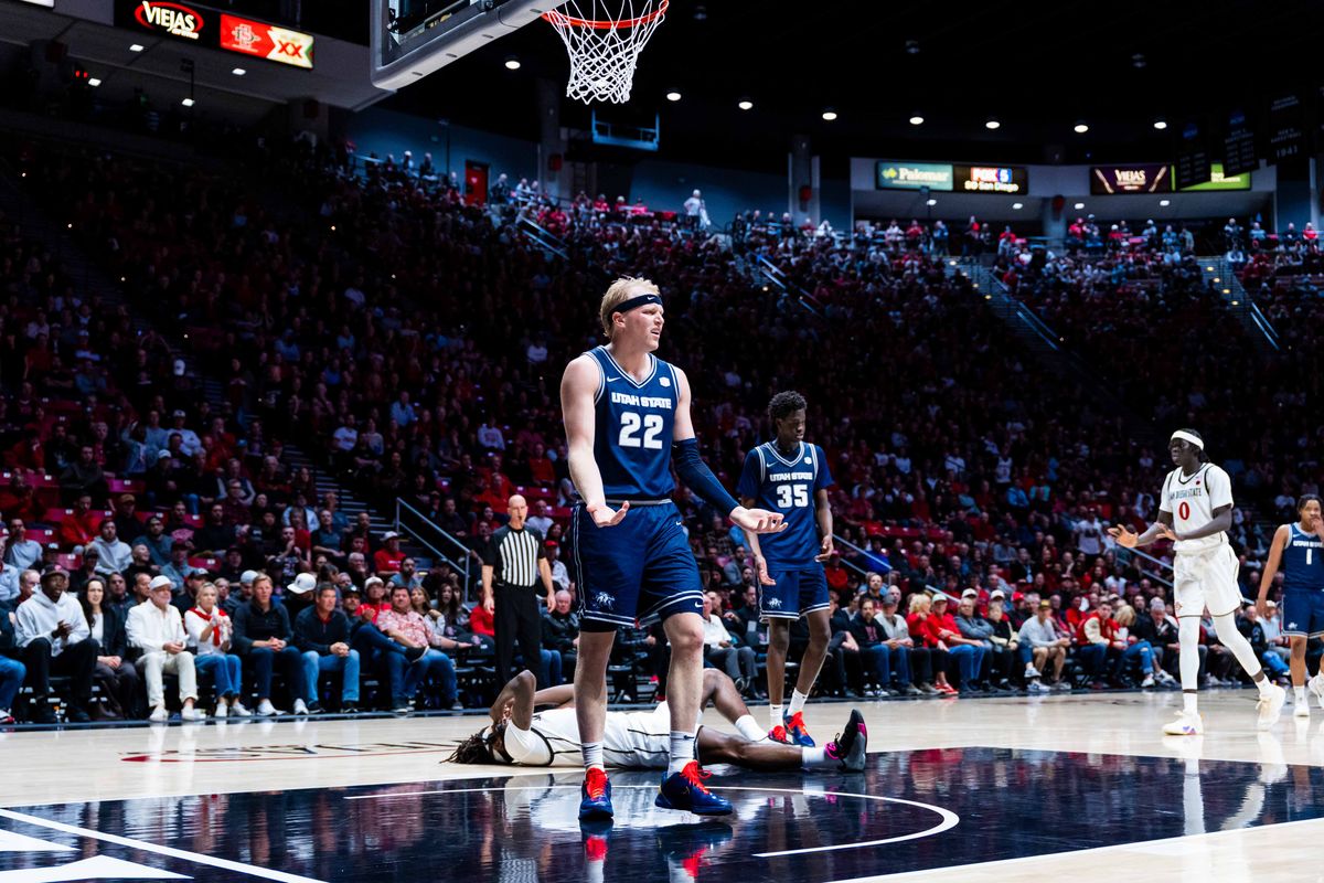 Utah State forward Karson Templin (22) reacts to being called for a foul against San Diego State forward Pharoah Compton (5) during an NCAA Basketball game between Utah State and San Diego State, Wednesday February 25, 2026 at Viejas Arena in San Diego, Calif.