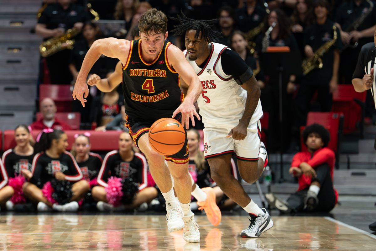 University of Southern California Trojans and San Diego State Aztecs players fight for a loose ball during the NCAA men’s basketball game, Friday, Oct. 23, 2026, at Viejas Arena in San Diego.