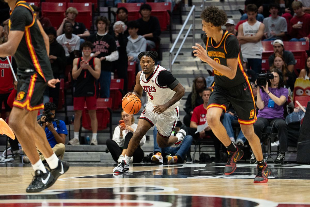 San Diego State Aztecs guard Latrell Davis (5) attacks the defense during the NCAA men’s basketball game against the University of Southern California Trojans, Friday, Oct. 23, 2026, at Viejas Arena in San Diego.